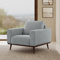 Fauteuil de salon contemporain en tissu bleu-gris clair avec piètement pivotant et assise profonde pour le salon