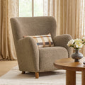 Fauteuil de salon contemporain en tissu bouclé taupe, avec dossier haut et assise profonde, pour salon